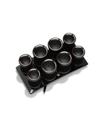 Set of black hot rollers with a matching black tray on a white background